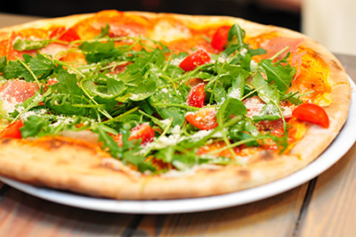 Arugula and tomato pizza